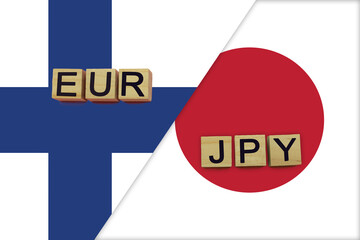 Finland and Japan currencies codes on national flags background