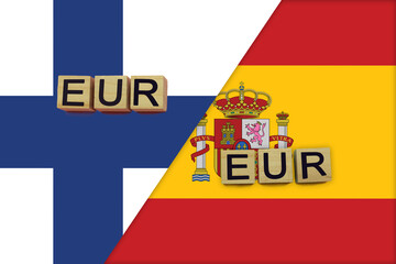 Finland and Spain currencies codes on national flags background