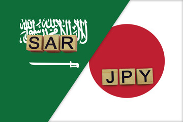 Saudi Arabia and Japan currencies codes on national flags background