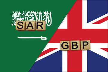 Saudi Arabia and United Kingdom currencies codes on national flags background