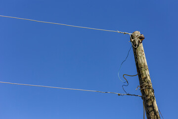 Old electricity pole and blue sky in Turkey.