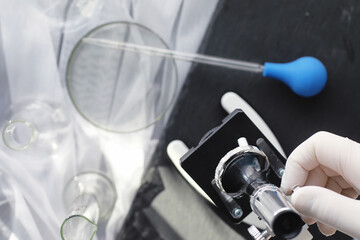 Laboratory research. Drug testing. Chemical experiments in the laboratory. Microscope various test tubes and beakers on the table at the medical officer.
