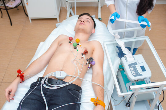 Cardiogram of the heart. Cardiologist is studying the testimony of an electrocardiograph. Cardiogram tape. Cardiology