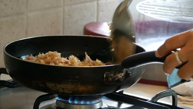 Finely chopped garlic being fried in a pan