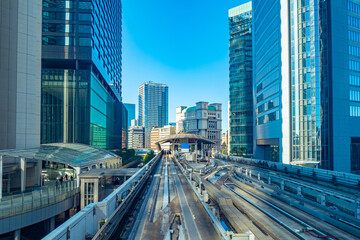 Fototapeta na wymiar Japan. A complex system of transport routes in Tokyo. Transport of the Japanese capital. Tokyo road infrastructure. Road and business center of the city. Railway tracks near the houses.