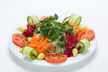 fresh vegetable salad with lettuce cucumber carrot tomato red cabbage parsley lemon olive oil