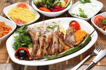 grilled lamb ribs served with tomato pepper and onion with sumac