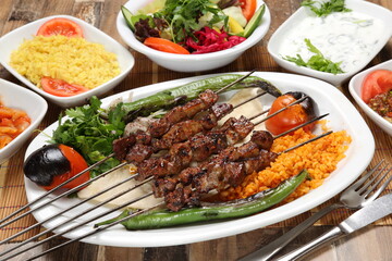 lamb liver skewers served with grilled tomato and pepper