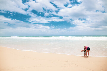 Fototapeta na wymiar Mother with his boy on a beautiful beach