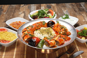 turkish adana beyti kebab wrap the adana kebab, pour over the butter and tomato sauce
