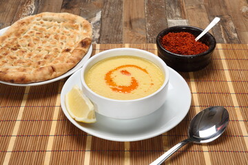Lentil soup served lemon slice and hot thin bread
