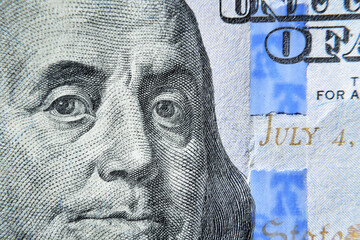 Dolar USA close up. Franklin eyes macro. The texture of the fragment of the dollar bill. USD...