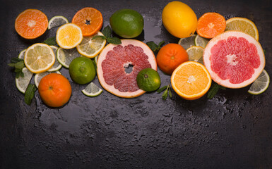 Citrus background. Fresh citrus fruits - Lemons, oranges, limes, grapefruits on wooden background.