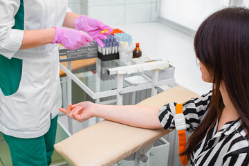 Takes blood for analysis. Blood sampling in the manipulation room.