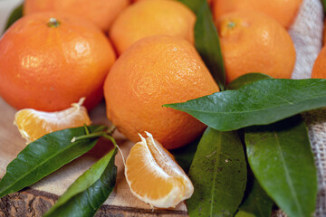 tangerines with leaves on a texture bag