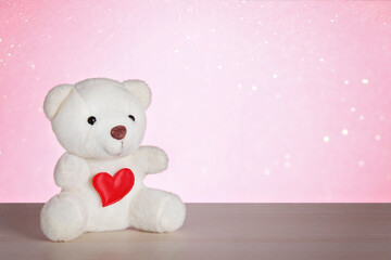 Teddy bear with heart on a pink background. Happy Valentine's Day, February 14th. Valentine's Day card. March 8, international women's day, mother's day.