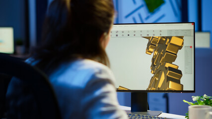 Focused woman architect working at new project using computer doing overtime at night sitting at...