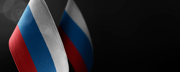 Small national flags of the Russia on a dark background