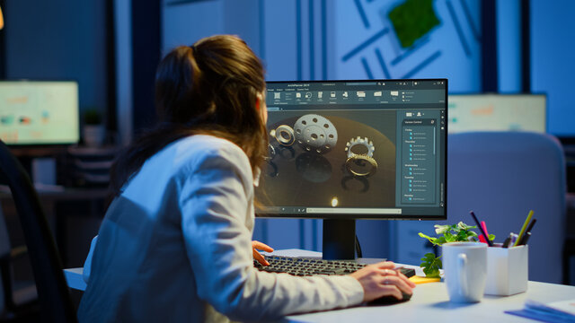 Woman Architect Working In Modern Cad Program Overtime Sitting At Desk In Start-up Business Office. Industrial Employee Studying Prototype Idea On Computer Showing Cad Software On Device Display