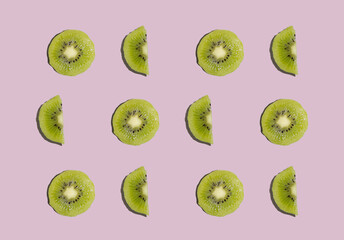 Fototapeta premium Kiwi isolated on pink background. Half of kiwi. Kiwi pattern. Food photography.