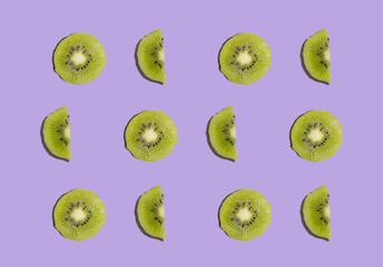Fototapeta premium Kiwi isolated on purple background. Half of kiwi. Kiwi pattern. Food photography.