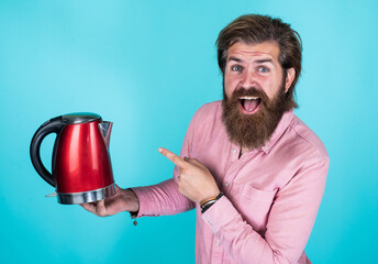 look over there. good quality. mature hipster with beard drinking tea. brutal guy with electric...