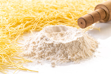 flour and pasta closeup on white