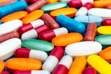Background of different colorful medical pills and capsules.