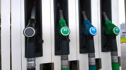 Fuel dispensing pumps green, blue and black colour at Petrol station. Gasoline service station. Oil and gas price concept. Nozzle background.
