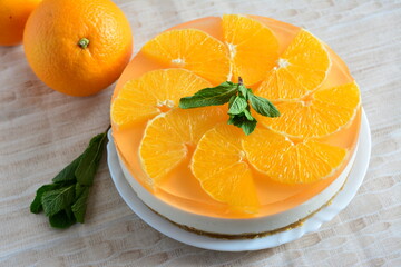 orange cheesecake with mint on the beige background