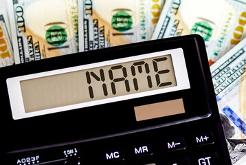 Calculator with text NAME on the dollars. Business, finance conceptual.