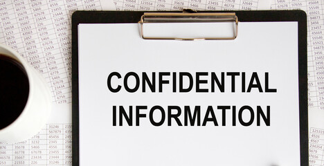 On the letter tablet, the text of confidential information, next to a mug of coffee, the background are reports.