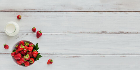 Heap of fresh strawberries in ceramic bowl on white background. Healthy eating and diet food concept.