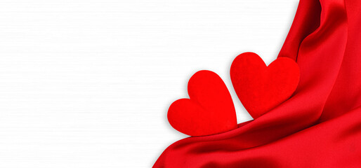 Wooden white background with red hearts and red satin. Concept of valentine day.