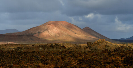 Beautiful volcanic landscape at sunset at the Parque Natural de Los Volcanes. Lanzarote, Spain.