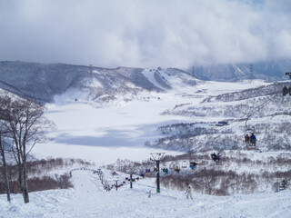 Overlooking downhill slope in a ski resort and snowy plain (Naeba, Niigata, Japan)