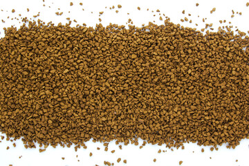 Instant granulated coffee scattered on white background. Top view. Copy space for text.