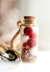 yarn red and white felted balls in bottle
