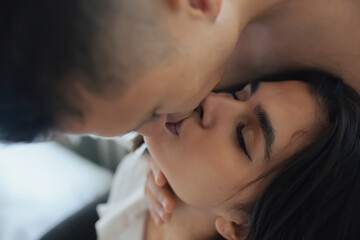 Close-up of couple in love kissing passionately with closed eyes. Cropped shot.