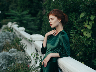 Woman in green dress outdoors nature luxury charm architecture