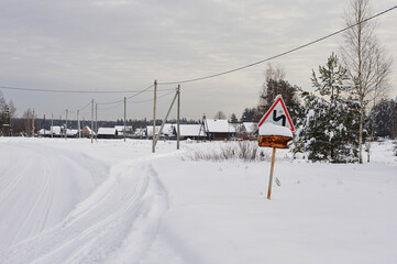 Winter snow village in the morning. Snowy winter village at dawn. Sunrise of winter village snow....