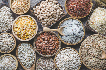 Variety kind of dry organic cereal and grain seeds in wooden bowl in dark tone, for healthy or clean food ingredient or agricultural product concept