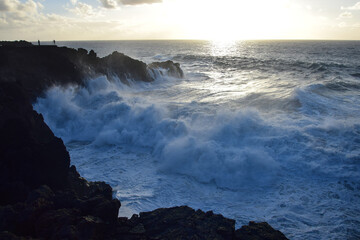 High waves at Los Hervideros in the evening sun. West coast of Lanzarote, Spain.