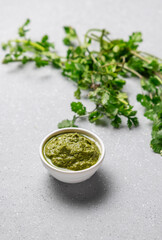 green coriander chutney in a white bowl