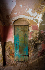 A door in a run down building in the historic medieval village of Scansano, Grosseto Province, Tuscany, Italy

