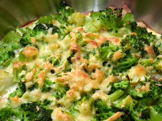 Broccoli with chicken and egg, baked in the oven in a round saucepan