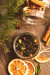 Obraz na płótnie Canvas Brewing black tea with cinnamon, orange, rosemary and candied fruit. Mix for mulled wine. Tea composition.