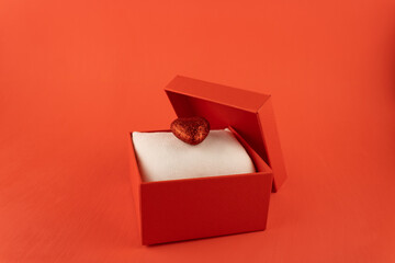 Red gift box with a shiny heart