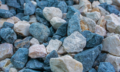 Stone background. blue gravel. Granite texture. The rocky road. Construction material. The texture of the stones. Wallpaper with fine gravel.