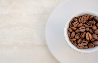 Coffee cup and beans on a white background. Top view with copy space for your text